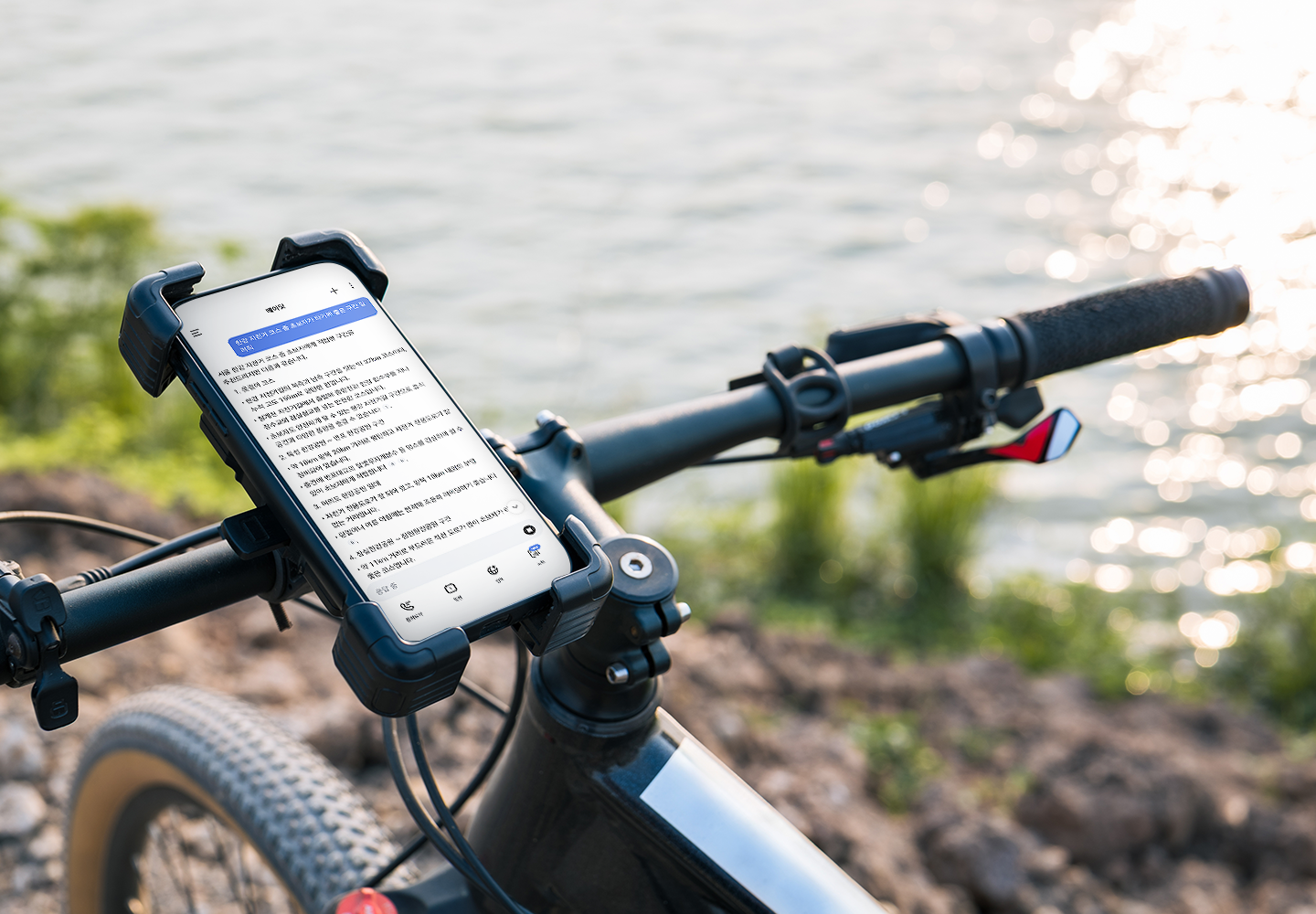 자전거 핸들에 거치된 스마트폰에 에이닷 대화 화면이 띄워진 모습.